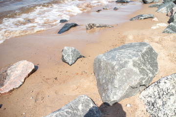 coastal wave with foam on a sunny day