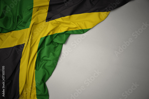 waving national flag of jamaica on a gray background. Tableau sur Toile