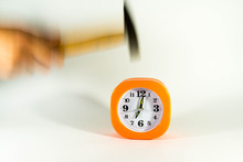 Man Hand Breaks The Alarm Clock With A Hammer, Visible Motion Blur , Focus On The Clock.