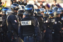 Helmeted Police Officers Photographed From Behind During A Protest