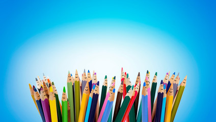 Poster - Colored pencils as faces of smiling children. Group of happy children. Friendship and communication children. kindergarten. Community of children with diverse ethnicity and culture. Copy space