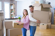 © Krakenimages.com - Young beautiful couple in love moving to new home, holding cardboard boxes very happy and cheerful for new apartment