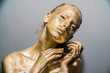 © de Art - Fashion model woman golden skin face in bright sparkles, Trendy glowing gold skin make-up. Glitter metallic shine   makeup
