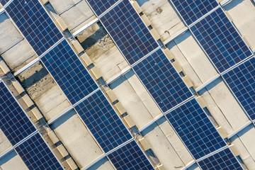 Top view of blue shiny solar photo voltaic panels system producing renewable clean energy abstract background.