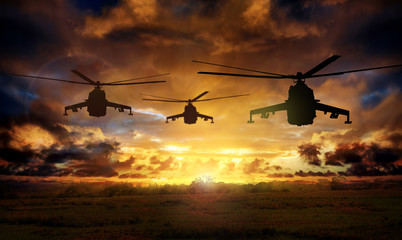 helicopter silhouettes on sunset background