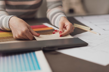 Professional decorator choosing fabric swatches