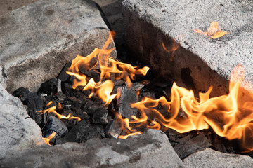 Charcoal burning in the grill. The fire in the grill. Kindle fire. Danger. Cooking.