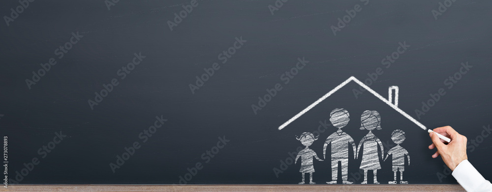 man is drawing roof on the family on chalkboard. home ownership concept - obrazy, fototapety, plakaty 