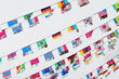 © mnimage - World flags decoration on white background, cloudy sky