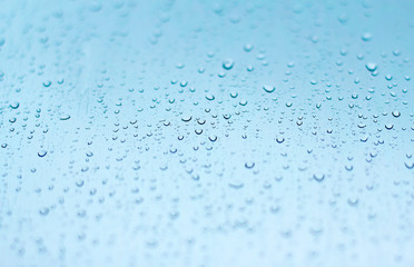 wet glass during rain. blue wet background