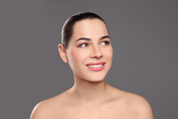 Sticker - Portrait of young woman with beautiful face and natural makeup on color background