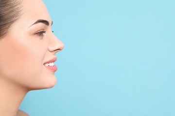 Poster - Portrait of young woman with beautiful face and natural makeup on color background, closeup. Space for text