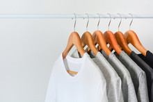 Close Up Collection Of Black, Gray And White Color (monochrome) Hanging On Wooden Clothes Hanger In Closet Or Clothing Rack Over White Background, Copy Space