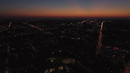 Wall Mural - Sunset over streets of big city, aerial view, United States