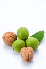 young and old walnuts with leaves isolated on whit background