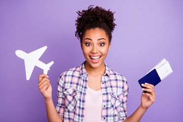 Portrait of funky funny cute lady enjoy free time hold hand paper plane want go tour excursion feel content positive dressed plaid stylish beautiful shirt isolated on purple background