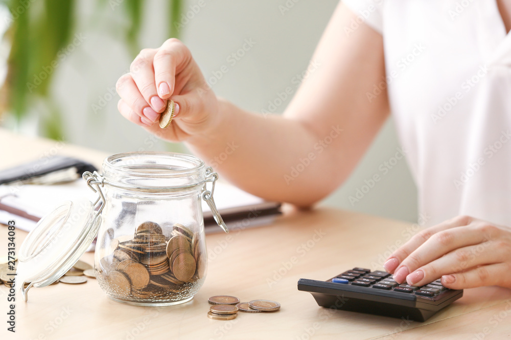 Young woman counting money at table, closeup