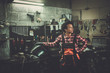 © Nejron Photo - African american woman mechanic repairing a motorcycle in a workshop