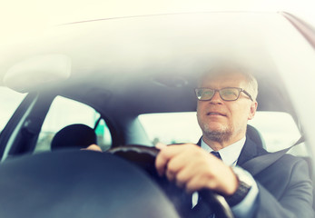 Canvas Print - transport, business trip and people concept - happy senior businessman driving car