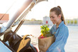 © pikselstock - Happy girl packing groceries