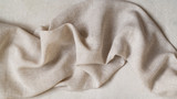 Fototapeta Tulipany - Flap of fine linen or hamp fabric on a gray background