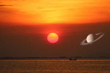 Wall Mural - Saturn on sunset sky back over sea and fishing boat
