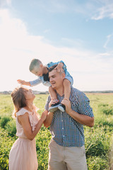 Happy family in park in sunny summer day