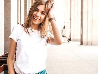 portrait of beautiful smiling blond model dressed in summer hipster clothes. trendy girl posing in t