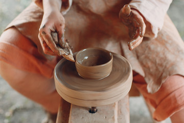 Potter makes a pot of clay