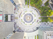 Aerial View Of A Traffic Circle Surrounded By Buildings In The Heart Of Singapore.