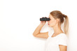 © primipil - Portrait of happy young woman model looking through binoculars. Searching gift concept.