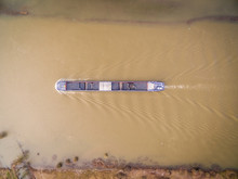 Aerial View Of Cargo Boat Transporting Goods On River, Olst, Netherlands.