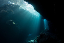 Light Descends Into The Darkness Of A Submerged Cavern In The Solomon Islands. Caves And Caverns Riddle Coral Reefs Since Limestone Can Be Easily Eroded.