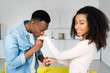 © LIGHTFIELD STUDIOS - boyfriend kissing hand of happy african american woman