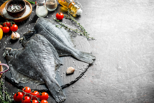 Raw flounder with cherry tomatoes, spices and garlic cloves. Poster Mural XXL