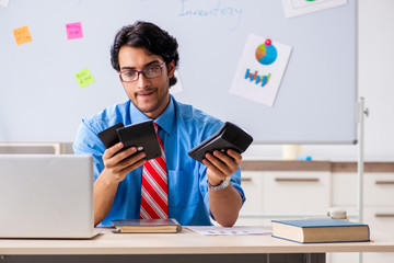 Young male financial manager working in the office 