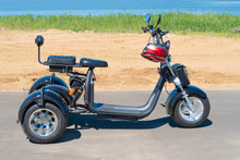  Three-wheeled Electric Motorcycle On The Beach. Walk On A Electric Scooter In The Summer.