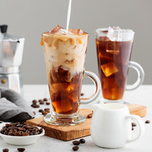 Summer Drink Iced Coffee Or Caffe Latte In A Glass With Milk And Coffee Beans.