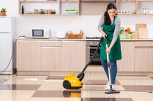Young Female Contractor Doing Housework 