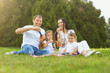 © Studio Romantic - Happy family has fun playing with soap bubbles on the grass in the park.