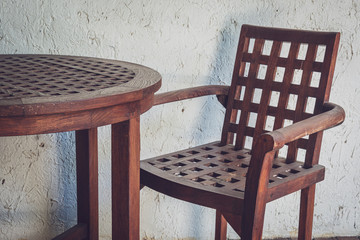 wooden chair and table in vintage filter.