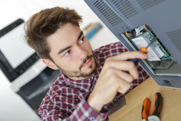 repairman repairing broken color printer