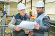 © auremar - industrial engineers looking at blueprint