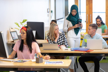 Wall Mural - Business people working at desk in a modern office