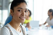 © WavebreakMediaMicro - Happy businesswoman looking at camera in a modern office