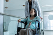 © WavebreakMediaMicro - Male doctor pushing pregnant woman on wheelchair in the corridor