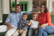 © WavebreakMediaMicro - Family watching television in living room at home