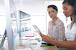 © WavebreakMediaMicro - Female graphic designers discussing on digital tablet at desk in a modern office