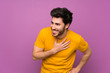 © luismolinero - Handsome over isolated purple wall smiling a lot