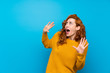 Redhead woman with yellow sweater nervous and scared